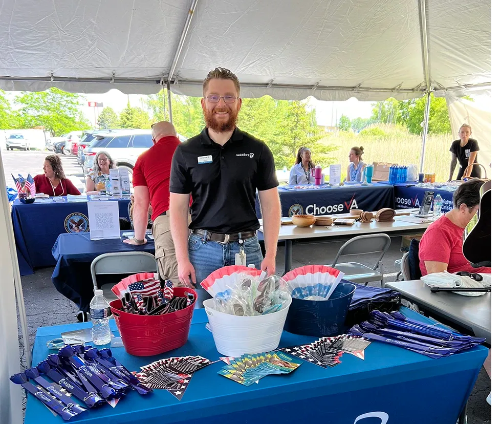Wildfire employee handing out trinkets and prizes at the Great Lakes Bay Vet Center Resource Fair