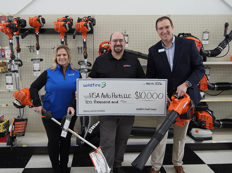 Wildfire presenting grant check for $10,000 to HSA Auto Parts owner.