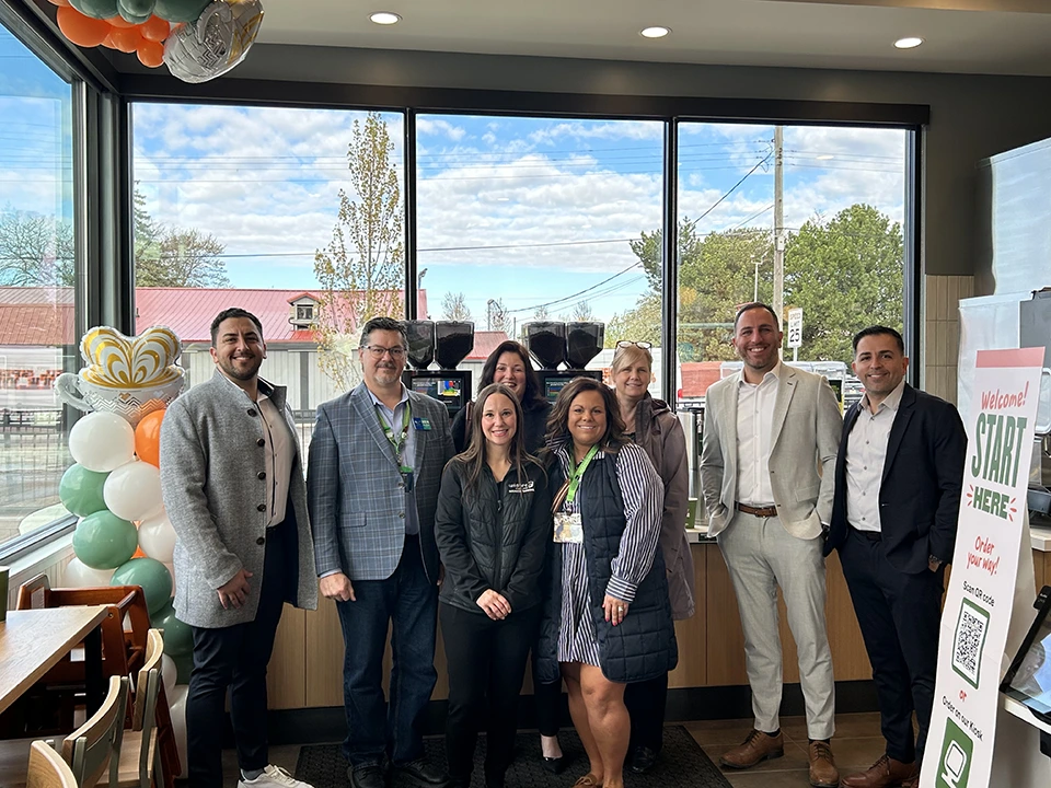 Wildfire Employees Celebrating with Panera Bread Wildfire employees smiling and celebrating with Panera Bread owners inside new location.