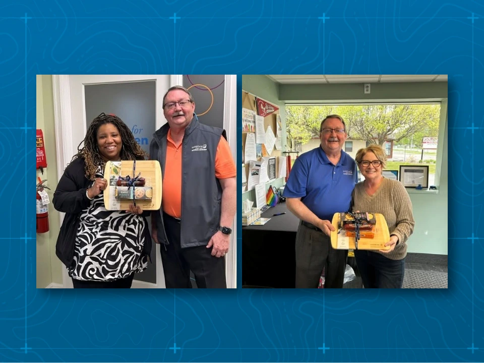 Jim Couture posing with local businesses with gifts for small business month.