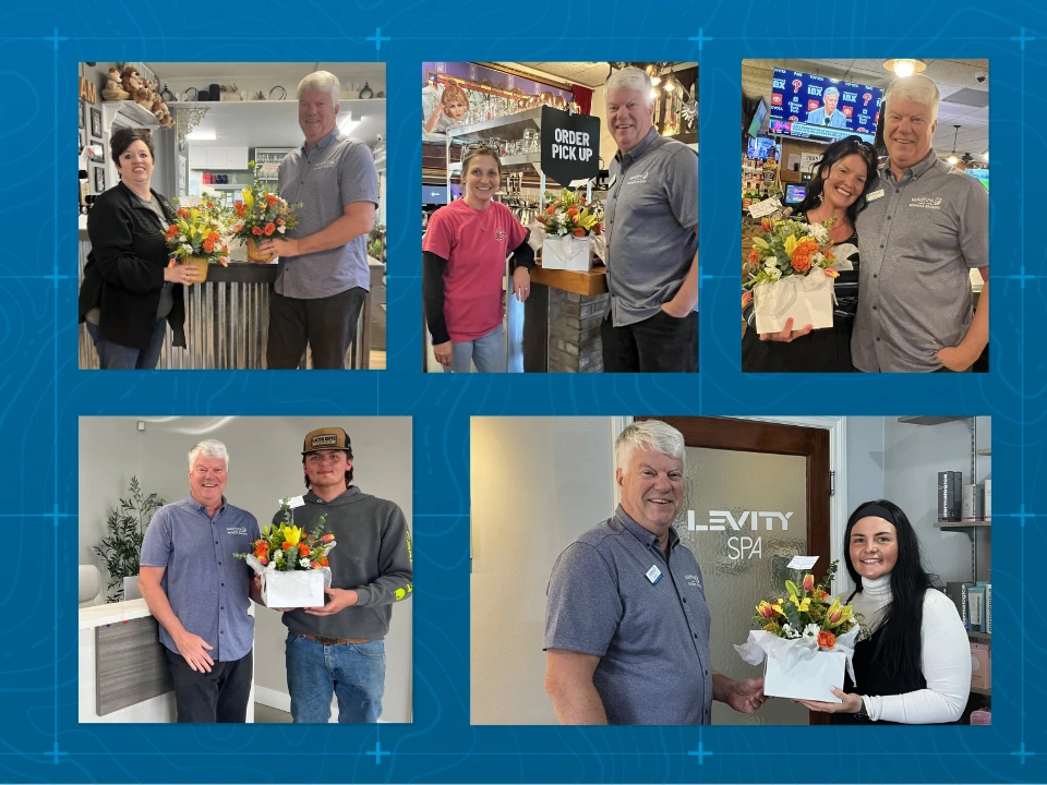 John Harken posing with local businesses with gifts for small business month.