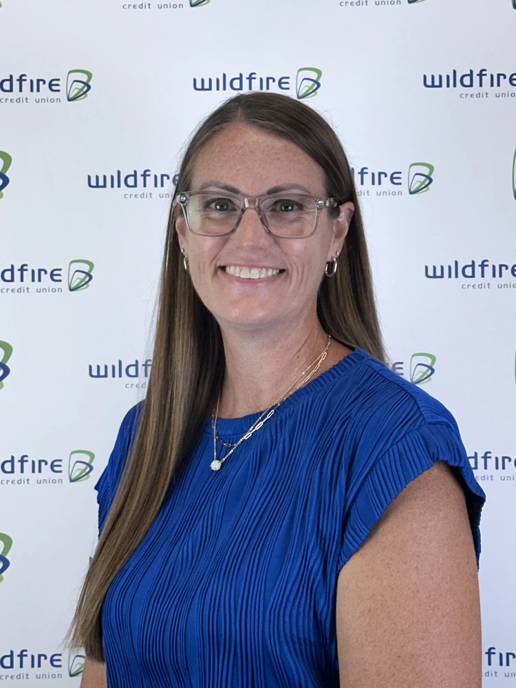 Rachael Klinski with Wildfire Credit Union logo on white background behind him.