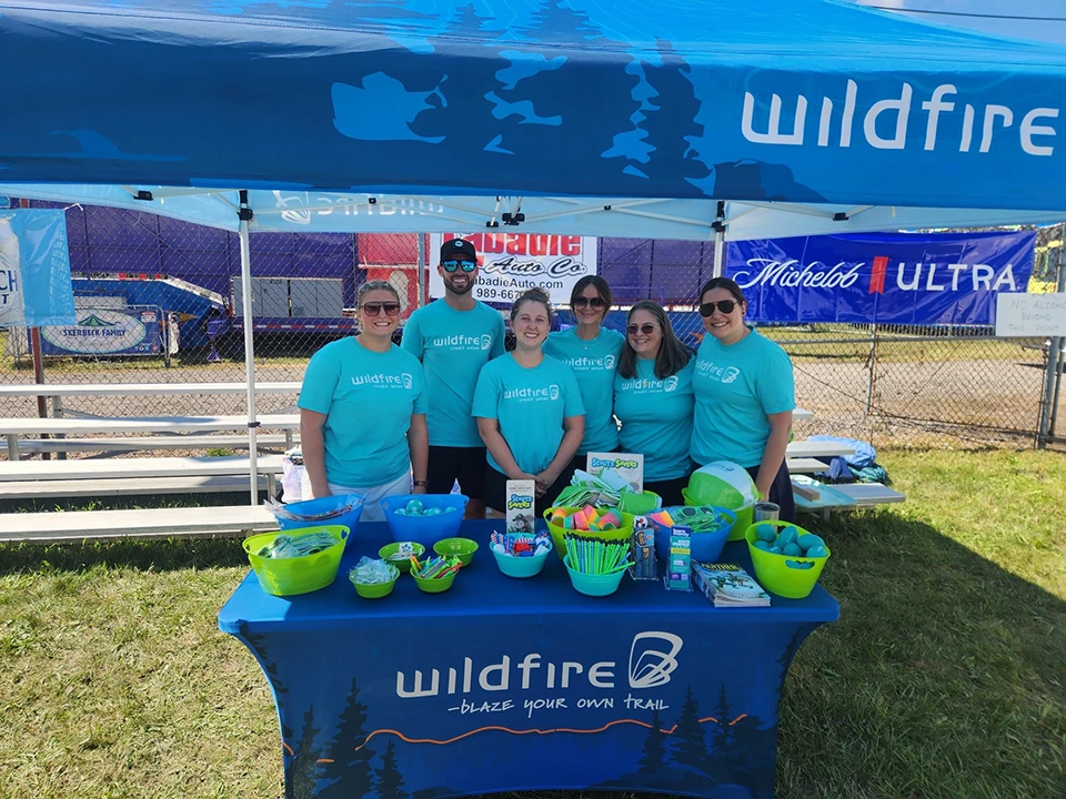 Wildfire employees hand out trinkets and prizes to kids and parents at St. Stan’s Polish Festival in Bay City.
