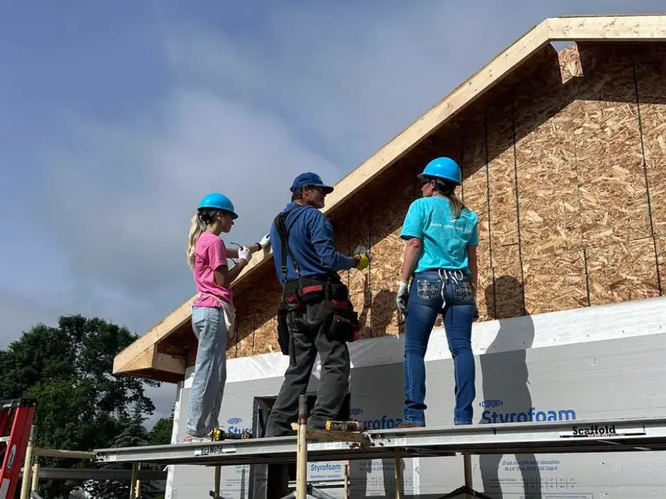 Wildfire's women employees spent the day in Midland building with Habitat for Humanity.