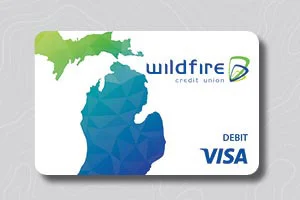 Michigan map design on white Wildfire Credit Union Visa debit card on gray topo background.