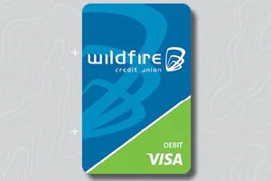 Blue and green default style Wildfire Credit Union Visa debit card on gray topo background.