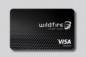 Black Wildfire Credit Union Visa card with a sleek textured design on a light patterned background.