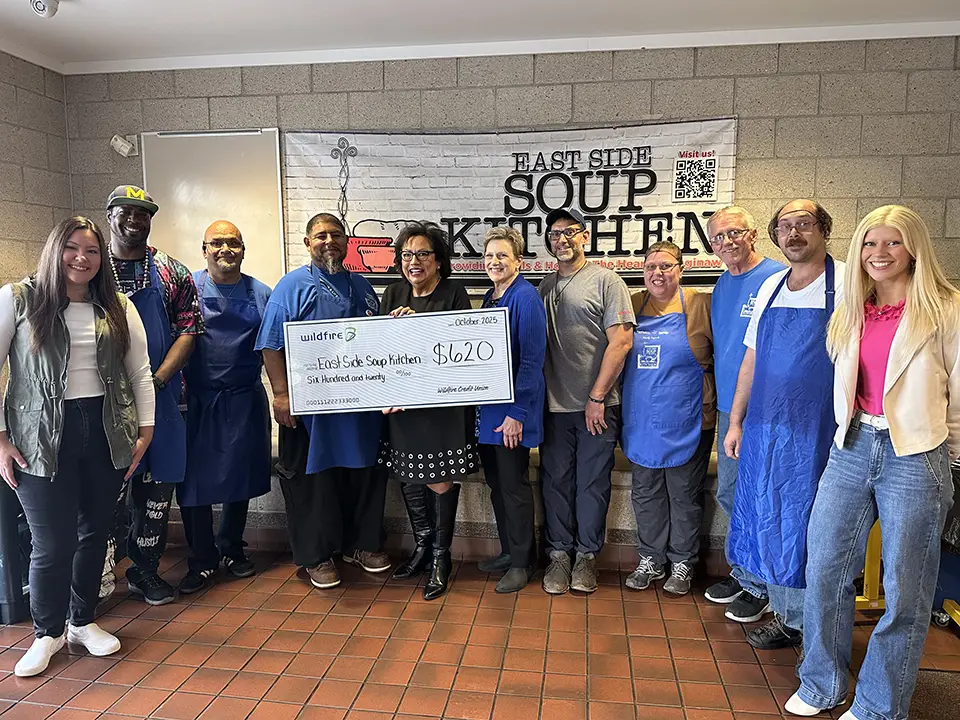 Wildfire employees and East Side Soup Kitchen staff smile for check presentation.