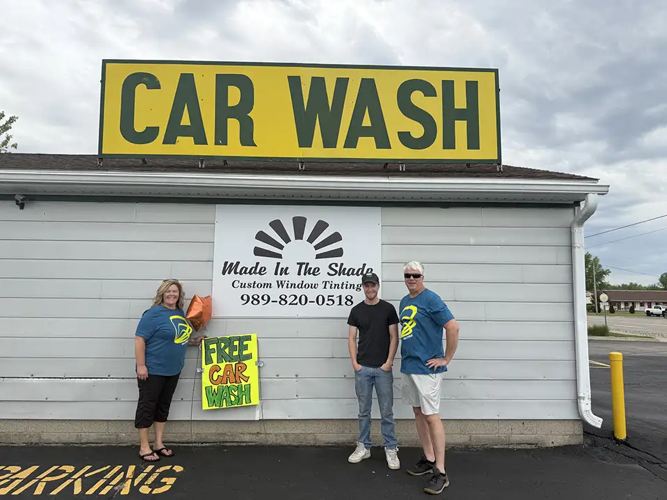 Two Wildfire employees with Made in the Shade Owner in front of car wash.