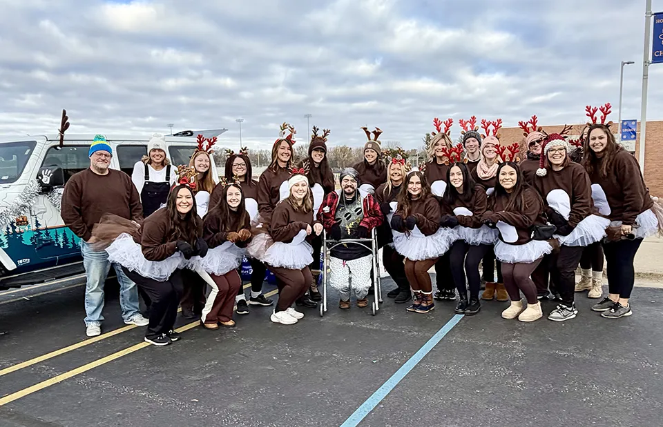 Wildfire employees dressed up as reindeer before start of parade in front of Wildfire Jeep.
