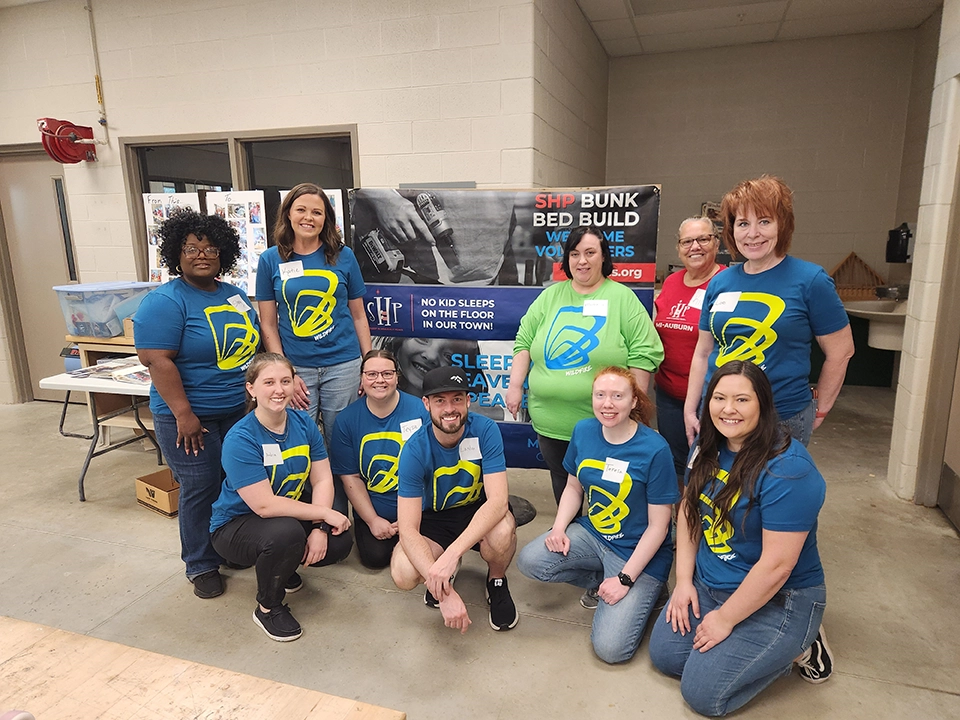 Group of Wildfire employees volunteering with Sleep in Heavenly Peace at Delta College.