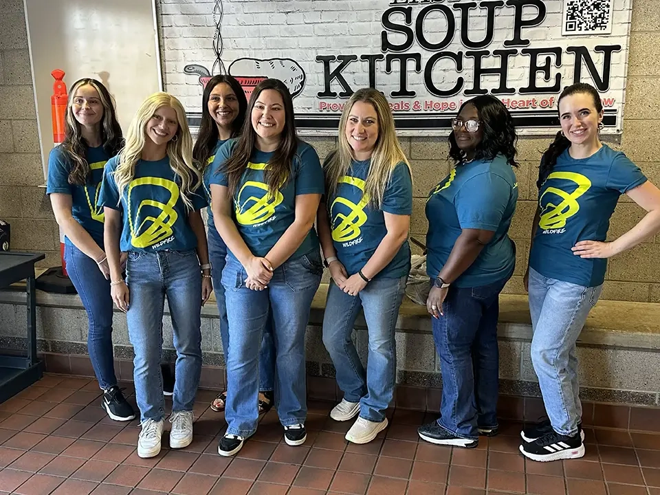 Wildfire team volunteers on 9/17/25 and smiles for photo at Saginaw's East Side Soup Kitchen
