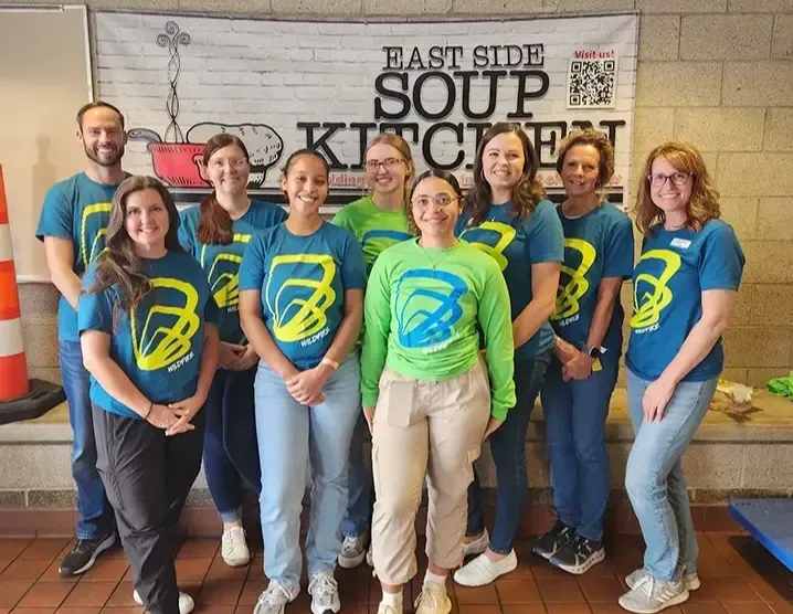 Wildfire team volunteers on 9/23/25 and smiles for photo at Saginaw's East Side Soup Kitchen