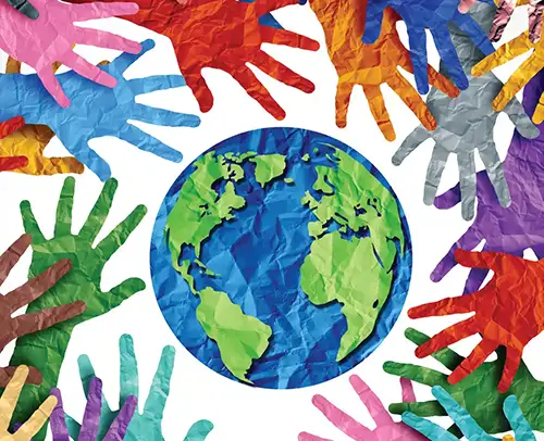 World globe with various different color paper hands around it.