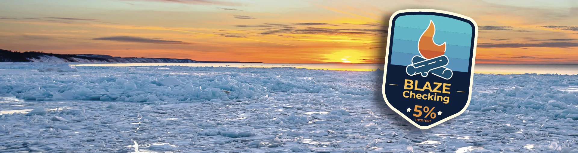 Blaze Checking badge with 5% interest with a background of Lake Michigan winter sunset.