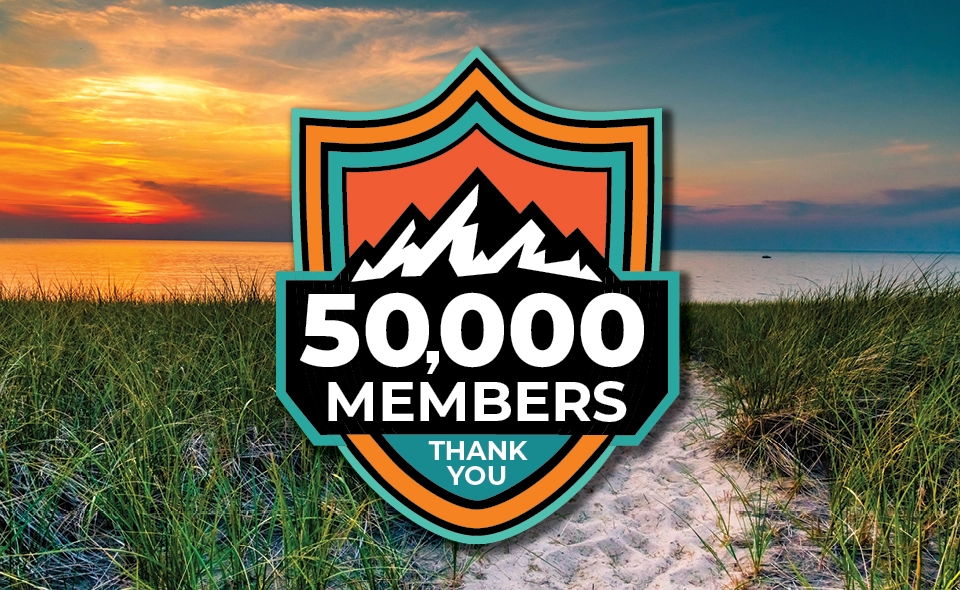 Sunset on a Michigan beach with a mountain badge of 50,000 members and thank you.