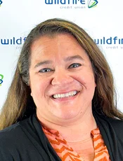 Dealer indirect loan officer Jessica Weis headshot on Wildfire logo background.